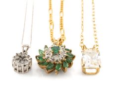 THREE 9CT GOLD PENDANTS comprising diamond cluster, cubic zirconia and emerald and diamond chip, all