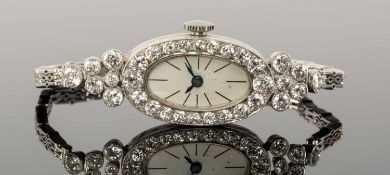 ART DECO 18CT WHITE GOLD & DIAMOND COCKTAIL WATCH, London 1923, silvered oval dial 25 x 14mms,