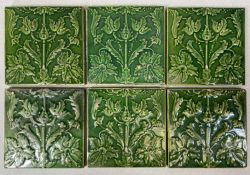SIX ART NOUVEAU GREEN GLAZED FIREPLACE TILES, stylised relief moulded decoration, 15.5cms²