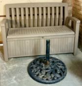 MOULDED PLASTIC GARDEN BENCH with storage seat and a cast metal parasol stand Provenance: private
