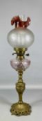 VINTAGE OIL LAMP with cast brass base and column, dimpled glass reservoir, etched clear and pink