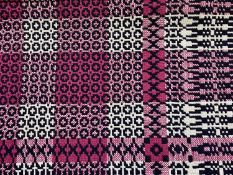 TRADITIONAL WELSH WOOLLEN BLANKET, geometric pattern in pinks and cream, against a black ground,