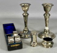ASSORTED SILVER COLLECTABLES, including three napkin rings; pair of candlesticks with weighted