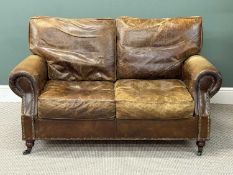 BROWN HIDE UPHOLSTERED TWO-SEATER SETTEE with studded detail, loose cushions, 80 (h) x 150 (w) x