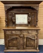 CONTINENTAL OAK SIDEBOARD, profusely carved, mirror back flanked by figure and twist turned columns,
