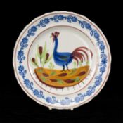 LLANELLY POTTERY COCKEREL PLATE, circa 1900, naively painted with a standing cockerel and plants,