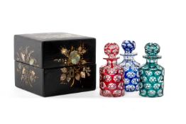 CHINOISERIE BOXED SET OF BOHEMIAN CASED GLASS SCENT BOTTLES, in red, green, and blue overlay, each