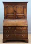 LATE 18TH. CARMARTHENSHIRE OAK BUREAU CABINET, upper with dentil cornice, fluted detail to frieze