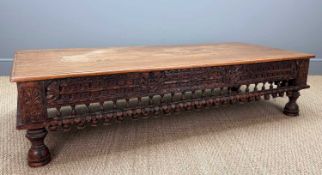 ANGLO-INDIAN CARVED LOW TABLE, probably teak, 41 (h) x 166 (w) x 78cms (d) Provenance: consigned via