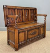 EARLY 20TH C. OAK MONK'S BENCH, applied carved oak decoration to panels, unusual flip and slide