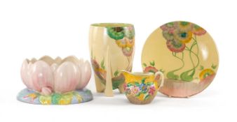 FOUR ITEMS OF CLARICE CLIFF, including lily shaped vase 23cms (w), 'Aurea' pattern vase 21cms (w)