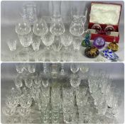 LARGE QUANTITY OF GLASSWARE, including cut-glass champagne flutes and other drinking glasses,
