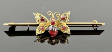9CT GOLD BUTTERFLY BAR BROOCH having ruby stones and seed pearls Provenance: deceased estate Ynys