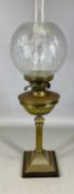 LATE 19TH CENTURY BRASS OIL LAMP with brass reeded column, circular reservoir, twin burners, and