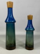 GÖRAN WÄRFF FOR PUKEBERG BLUE / GREEN GLASS TROPICO DECANTERS, with teak stoppers, 39 and 29cms (