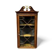 EDWARDIAN MAHOGANY CORNER CUPBOARD, pierced scrolled pediment with brass rosettes and central