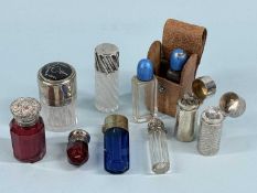COLLECTION OF SILVER MOUNTED GLASS SCENT BOTTLES, some in coloured glass; together with pair of
