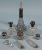VARIOUS CUT-GLASS SCENT BOTTLES & DRESSING TABLE JARS, with silver mounts Provenance: private
