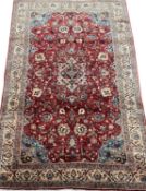 PERSIAN RED GROUND HANDMADE WOOL RUG, 278 x 175cms Provenance: private collection Conwy