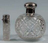 TWO CUT-GLASS SCENT BOTTLES, globular with hinged silver cover, 14cms (h); and cylindrical with