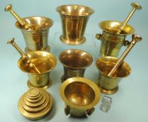 SEVEN BRONZE & BRASS MORTARS, with four brass pestles and nest of brass weights Provenance: