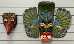 INDONESIAN CARVED & BRIGHTLY COLOURED BIRD MASK, 57 x 47cms; and a further carved wooden mask, 27cms