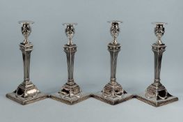 SET OF FOUR GEORGE III SILVER TABLE CANDLESTICKS, each on square base, with swags and bead