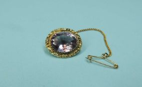 VICTORIAN AMETHYST BROOCH with chased decoration, in unmarked gold, 20mms, gross weight 5.06g
