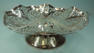GEORGE V SILVER NUT BOWL, Birmingham 1934, pierced form on a circular spreading foot, 23cms (diam.),