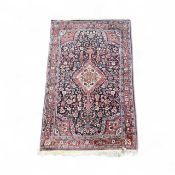 IRANIAN HANDMADE WOOL RUG, red and blue ground with floral centre field, floral border, 162 x 103cms