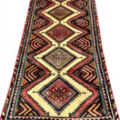 PERSIAN HANDMADE WOOL RUG, red, blue and cream geometric pattern, 250 x 82cms Provenance: private