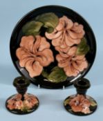 MOORCROFT CORAL HIBISCUS CIRCULAR PLATE, on green ground, c. 1980, signed with 'W. M.' monogram,