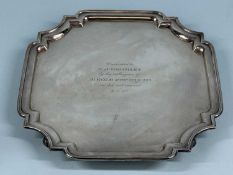 GEORGE VI SILVER WAITER of square form, moulded rim with re-entrant corners, on four scroll feet,