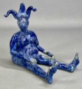 LOUISE SCHREMPFT (British contemporary) pottery figure of a seated jester, blue mottled glaze, 14.