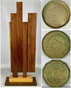 ABSTRACT MAHOGANY SCULPTURE, 82cms (h) with various circular Eastern brass trays Provenance: private