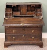 18TH CENTURY OAK BUREAU, fall front enclosing fitted interior with well, over three long drawers,