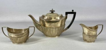 EDWARD VII COMPOSITE THREE-PIECE TEA SET, of oval form with gadrooned decoration, teapot having
