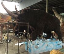 Animatronic Woolly Rhinoceros standing on a rock, Dimensions Approx. Height 3m, Length 3.8m, Gross