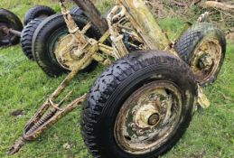 A set of sprung trailer axles with wheels and A frame