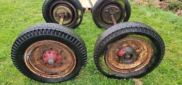 A pair of trailer axles with wheels