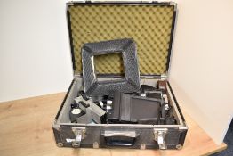 An alloy camera case containing various Sinar parts