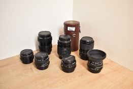 Seven camera lenses. A Pentax M 1:2,8 28mm, a SMC Pentax-A 1:2,8 28mm, a SMC Pentax-A 1:1,7 50mm,