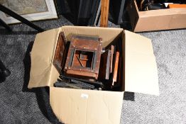 A box of mahogany field camera parts