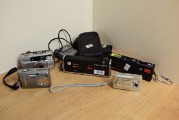 A selection of cameras. A Minolta Pocket Autopak 460TX, a Boots Pocket 110EF, a Pentax ESPIO 838G