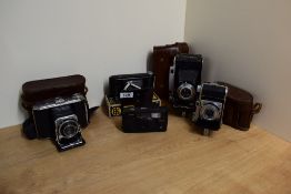 Five Kodak cameras. A boxed Kodak Jiffy VP, a Kodak Modele 36 folding camera, a Kodak Retina, a