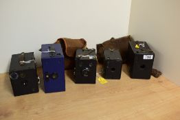 Five Box cameras. A Kodak Hawkeye No Model B, a Kodak 620 Junior O, a Houghton Ensign, an Ensign E29