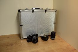 An Olympus OM10 camera with OM-System Zuiko Auto-S 1:1,8 50mm lens, OM-Systam E Zuiko Auto-T 1:3,5