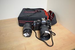 A Nikon F301 camera with Sigma Zoom 1:3,5-4,5 28-70mm and Sigma Zoom 1:4-5,6 70-210 lens