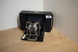 A folding box camera with Ensign Anastigmat 6in focus Series I NoI lens having retailers