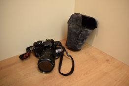 A Pentax P30 camera with Pentax-A Zoom 1:3,5-4,5 28-80mm lens